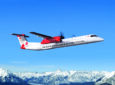 De Havilland dash 8-400 inflight over the snowy mountains.