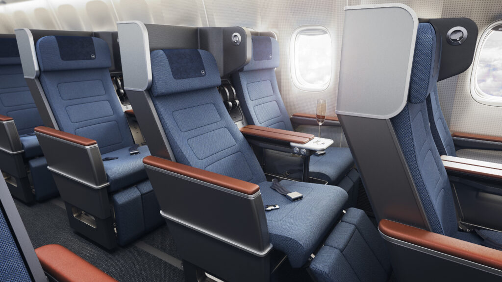 ZimPrivacy Premium Economy class seat on a Lufthansa aircraft. The seat is navy blue with dark wood-like accents and armrests. Part of the new Lufthansa Allegris interior.