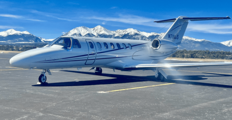 A flyExclusive aircraft is parked at the airport.