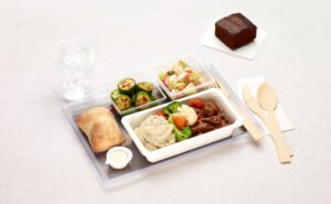 Air Canada Meal is being displayed with wooden cutlery on a white table.