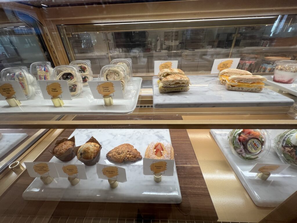 Various food options are displayed in the Amtrak Metropolitan/ lounge in Moynihan Train Hall