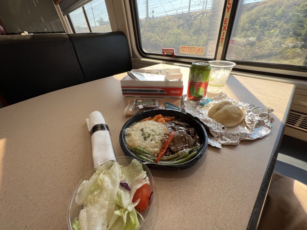 A meal is displayed on a table in the Amtrak dining car