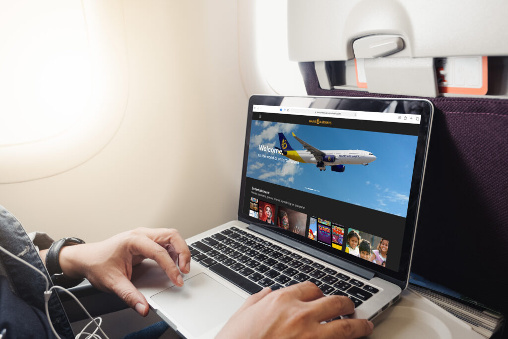 A passenger uses Hans Airways' streaming entertainment on his own laptop; the IFE is provided by French firm Moment