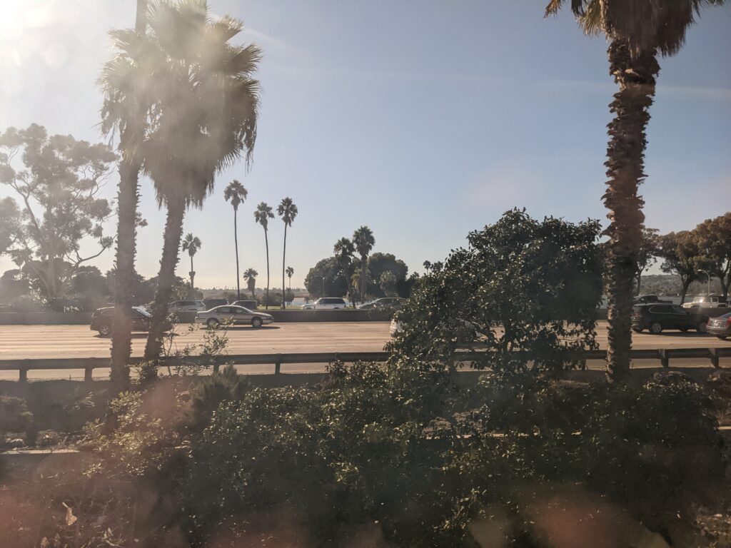 Looking out the window of the Pacific Surfliner as the train overtakes cars on the interstate