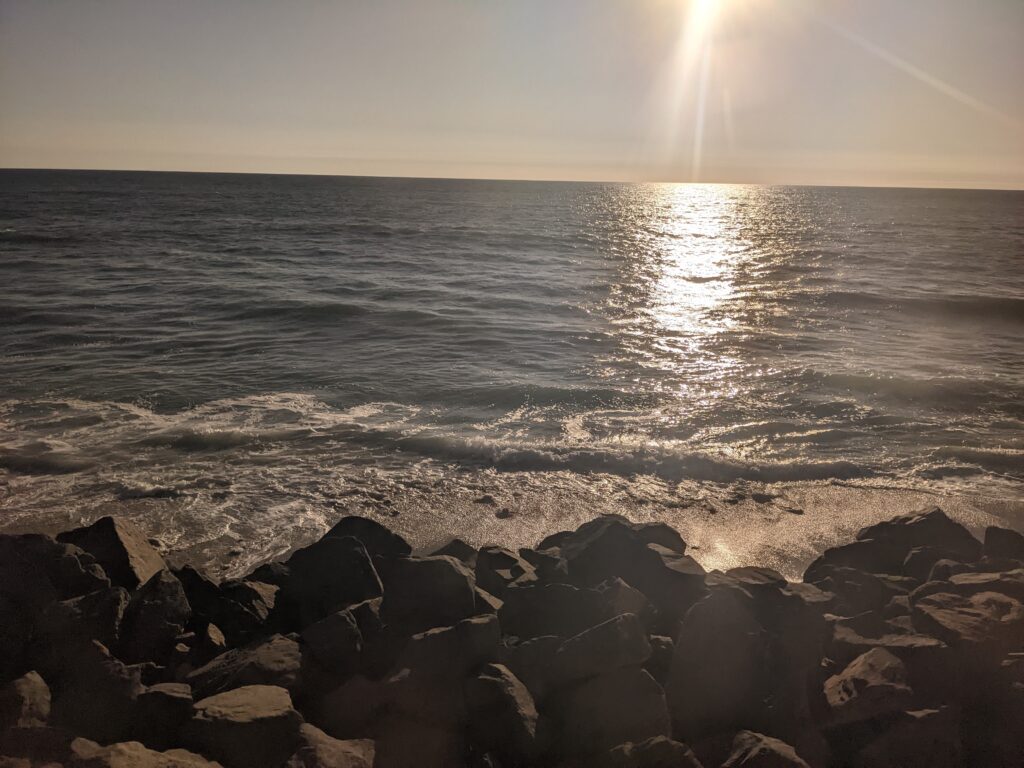 The afternoon sun over the Pacific Ocean as seen from the Pacific Surfliner window.