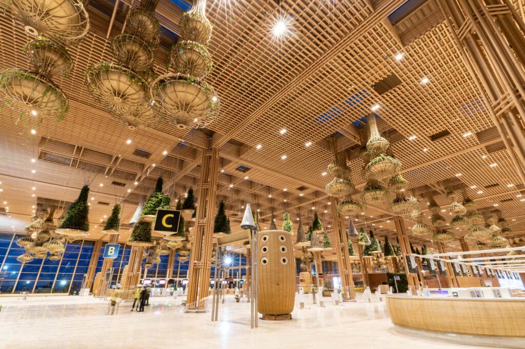 BLR Airport Terminal 2 has a bamboo aesthetic throughout. Plants hang from the ceiling