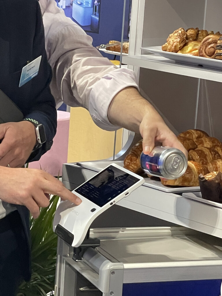 A person is seen scanning a can of soda.