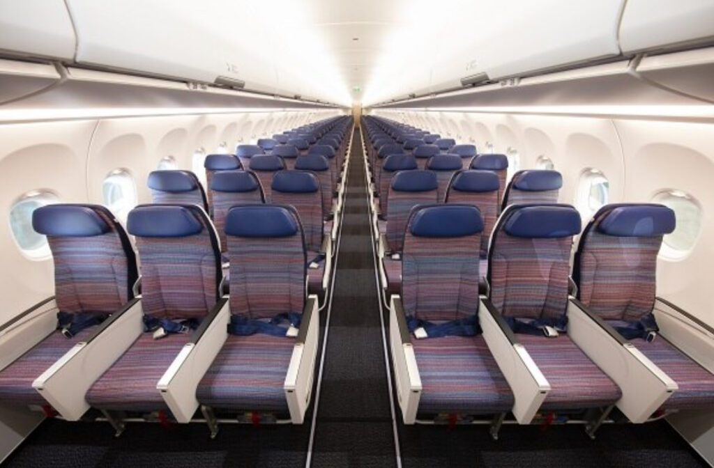 Korean Air A321neo economy class, head-on view of striped seats with blue headrests