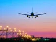 Landing airplane during sunset. Representing air travel and aviation industry.