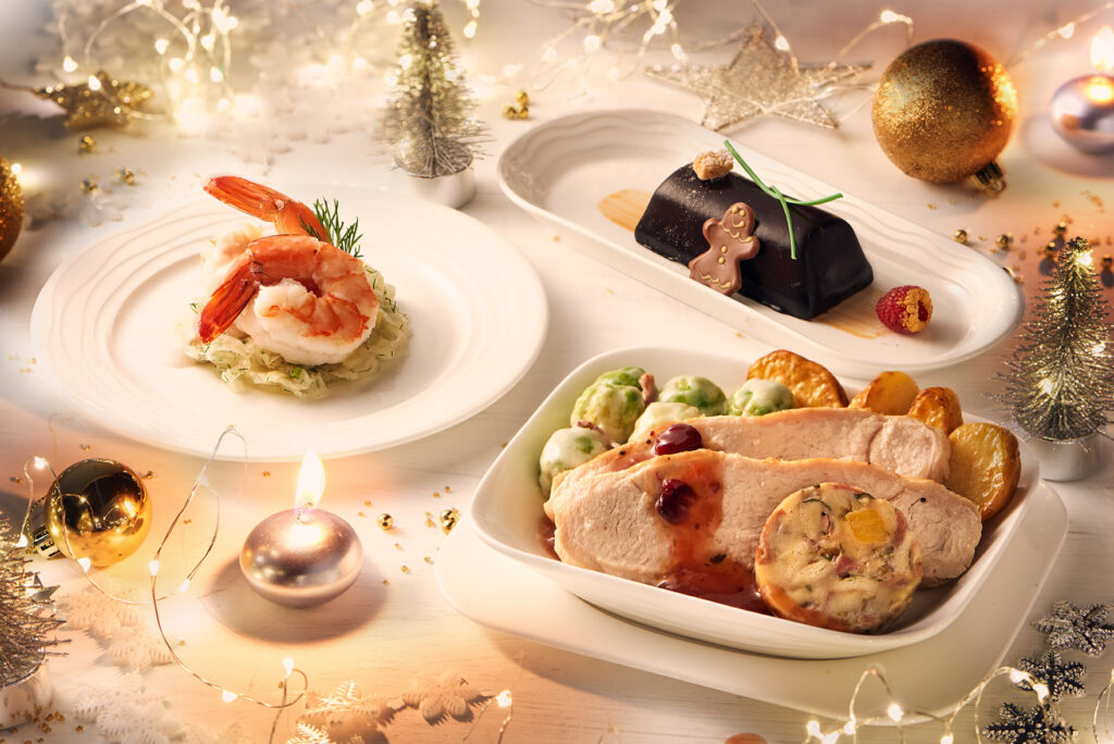 A festive Christmas turkey dinner is displayed next to King prawns.