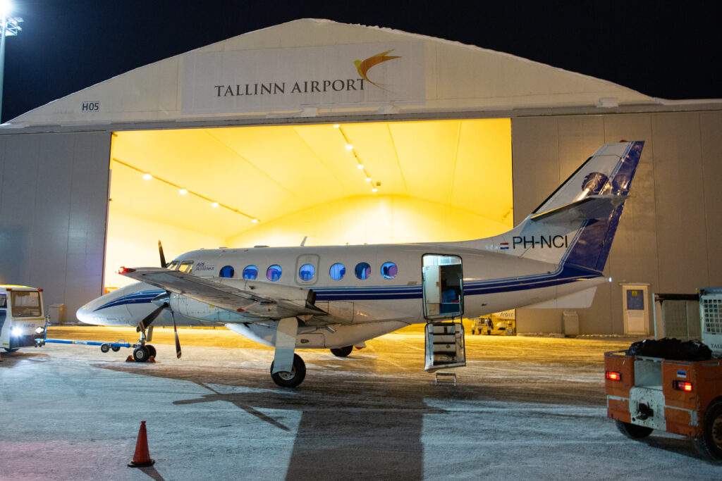 Transaviabaltika Jetstream 31 in front of a Tallinn Airport hanger.