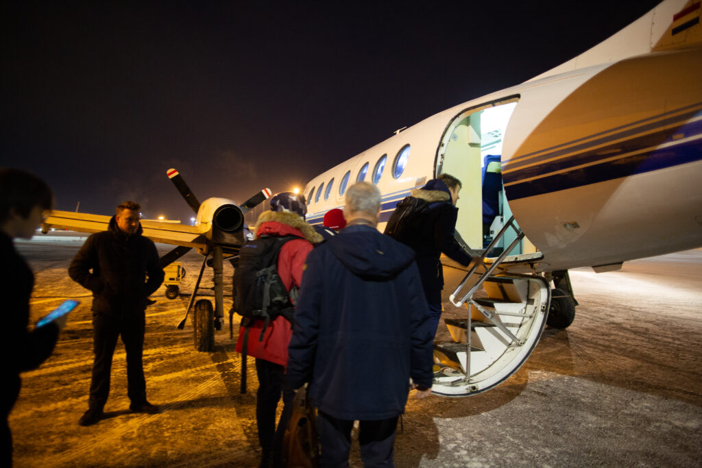 Passengers are boarding via jet stairs of a Transaviabaltika Jetstream 31 on a cold winter day.