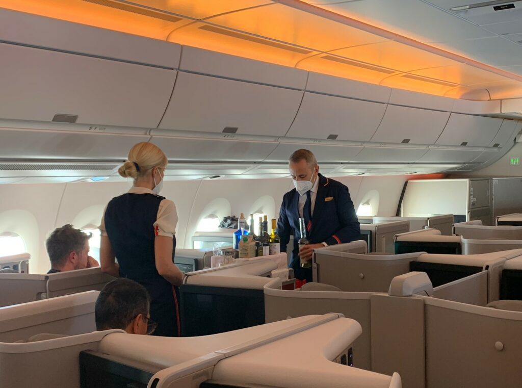 Two flight attendants serve drinks onboard the Iberia A350 NPS