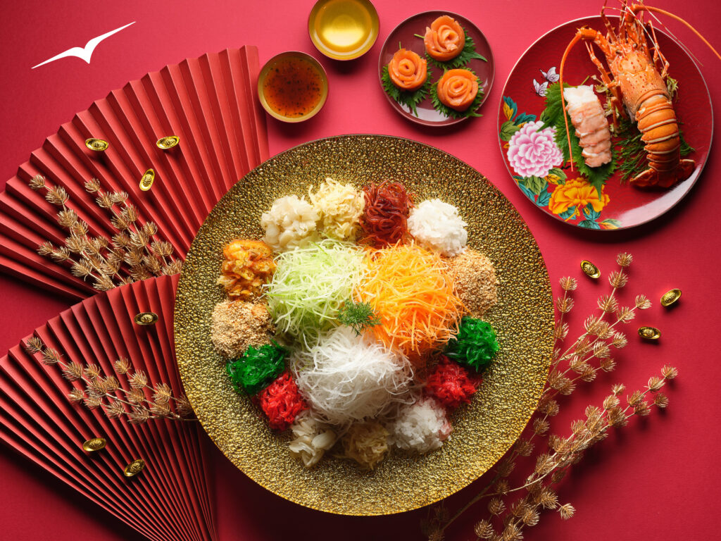 The Lo Hei meal that will be served to celebrate the Lunar New Year on VistaJet flights. The meal features many different colors; lobster tails are parked on a side plate.