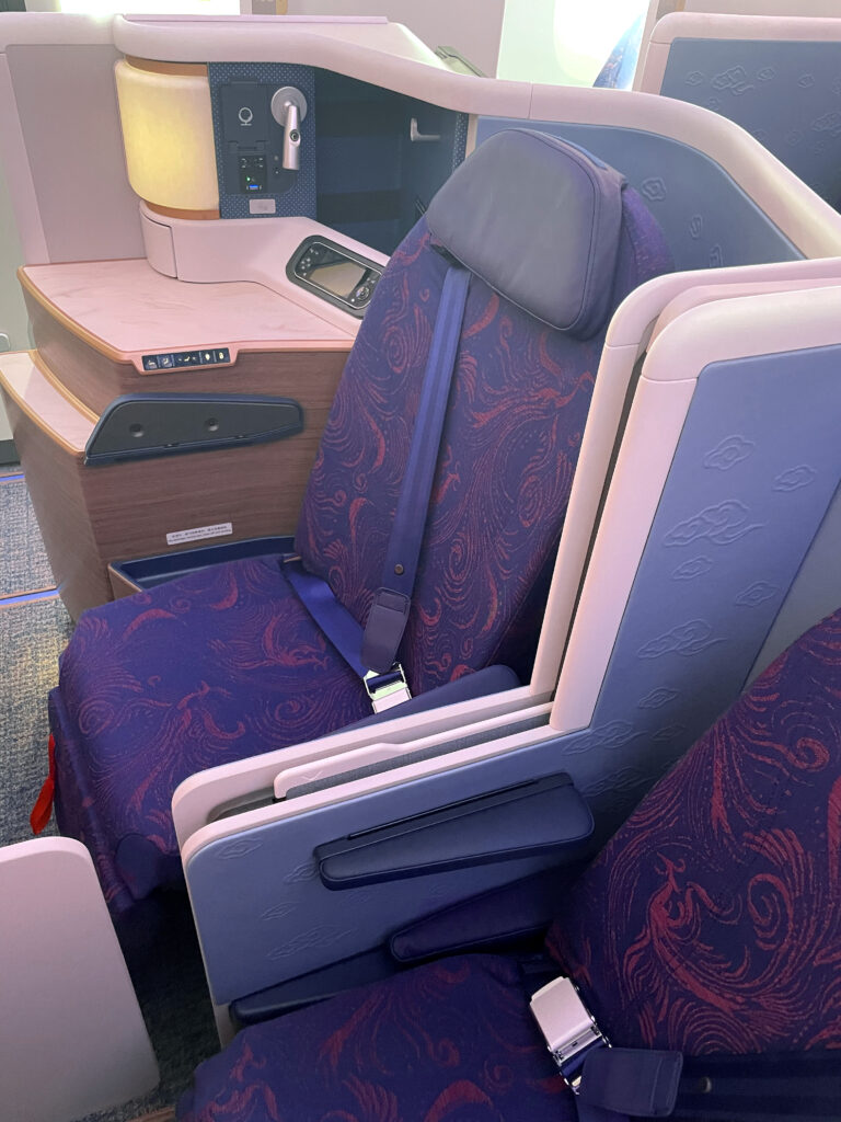 Various blues adorn the aircraft seats with a red phoenix pattern on the seat cover. 