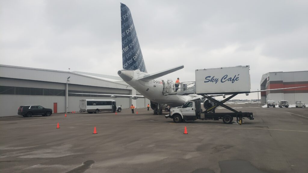 Sky Café catering loading meals on board Porter's E2 parked at the FBO.