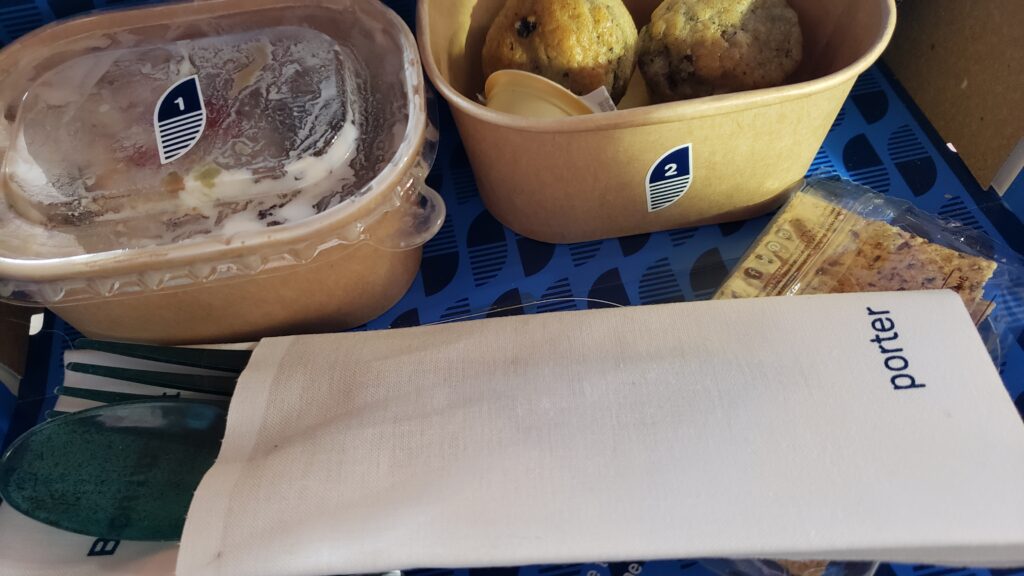 The contents of the first meal box, including olive puff pastries and the seven-layer dip. 