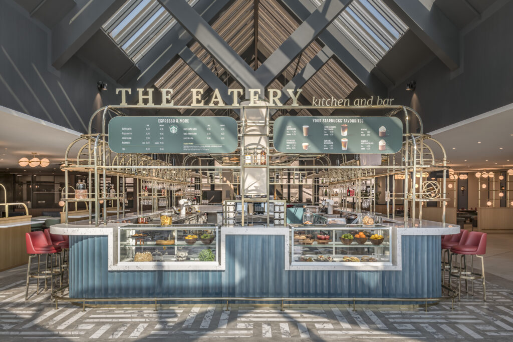 A vintage looking space, The Eatery features brass trim and red high top chairs.