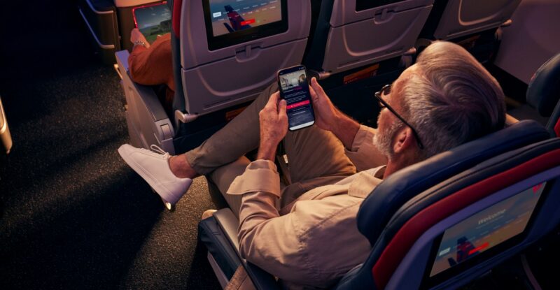 A Delta customer connects to free Wi-Fi while seated in Delta Comfort+