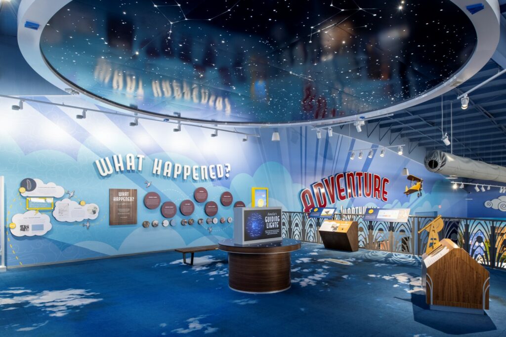 Above the Clouds station is blue with images of clouds on the wall. It features various podiums and screens to facilitate learning.