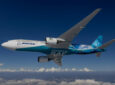 A Boeing aircraft in-flight over snow covered mountains.