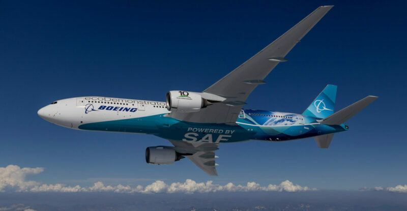 A Boeing aircraft in-flight over snow covered mountains.