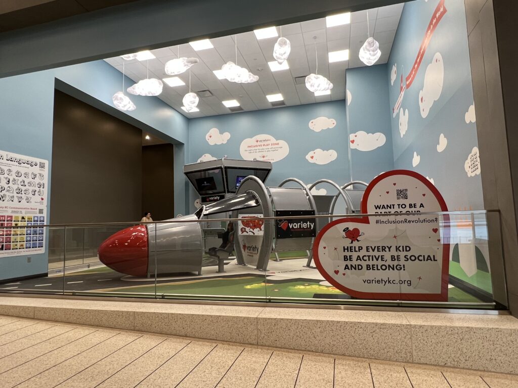 A room is painted to look like a sky with blue walls and clouds. An aircraft installation in the middle of the room allows children to climb and play in it.