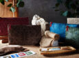 Emirates amenity kits in various colors including green, blue, brown and red are made with rice paper.