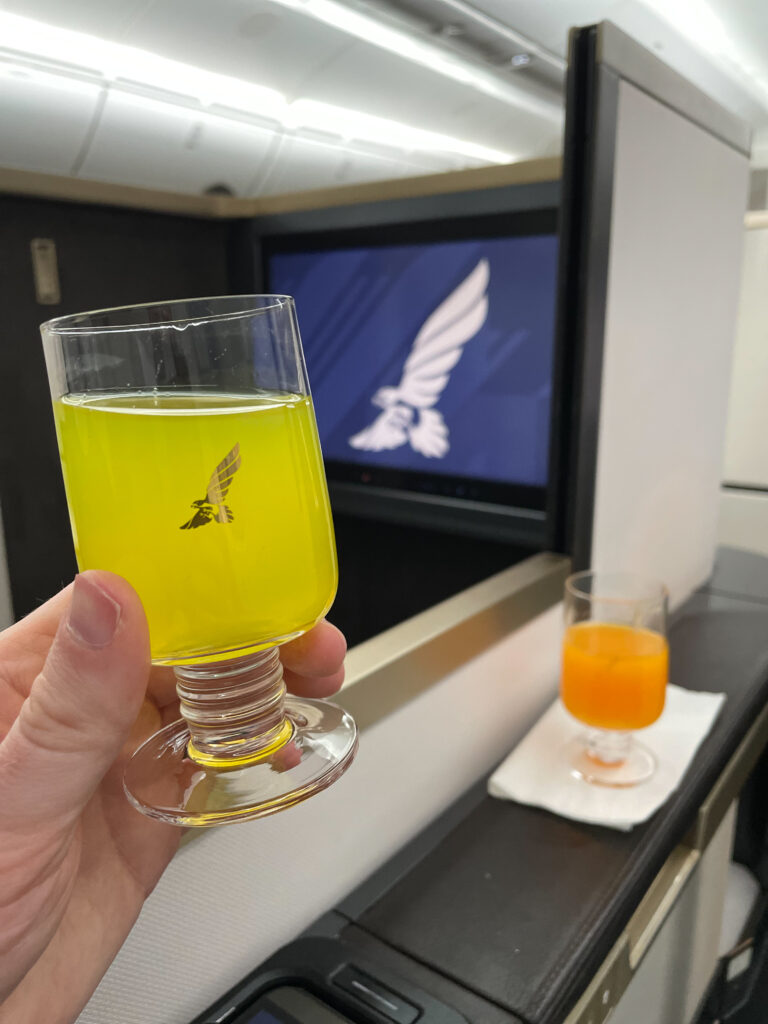 The author is holding up a juice on board this Gulf Air 787 flight.