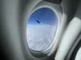 Looking out of the cabin window of a Delta A220 in flight