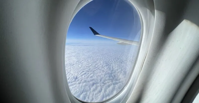 Looking out of the cabin window of a Delta A220 in flight