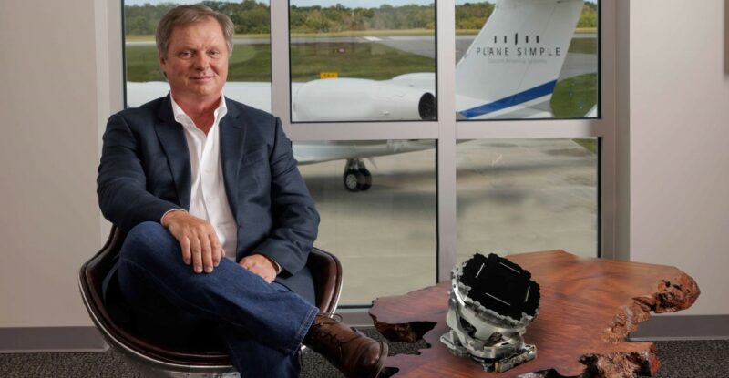 Satcom Direct CEO and Founder Jim Jensen with Plane Simple Ku-band tail-mount antenna.