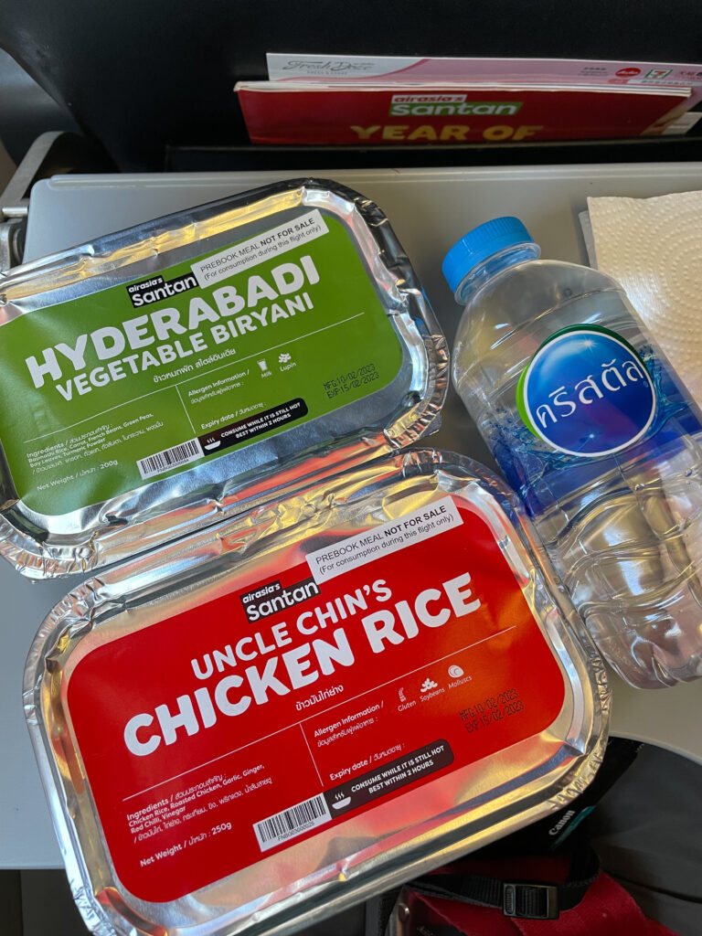 The inflight meals are displayed on the tray table on board the Thai AirAsia flight