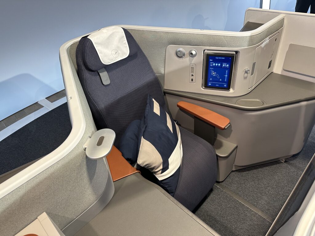 Lufthansa Allegris business class seat on display. This "Extra Space Seat" shows ample space within a thermoplastic suite.