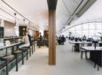 Cathay Pacific's The Deck lounge at Hong Kong International Airport. Floor to ceiling windows brighten a sleek open space with various seating.