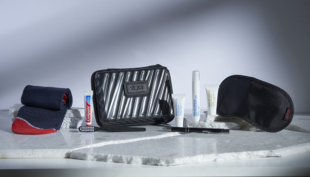 Air India Business Class Kit by Buzz is displayed on a white table and includes toothpaste, hand cream, socks, a sleep mask and more.