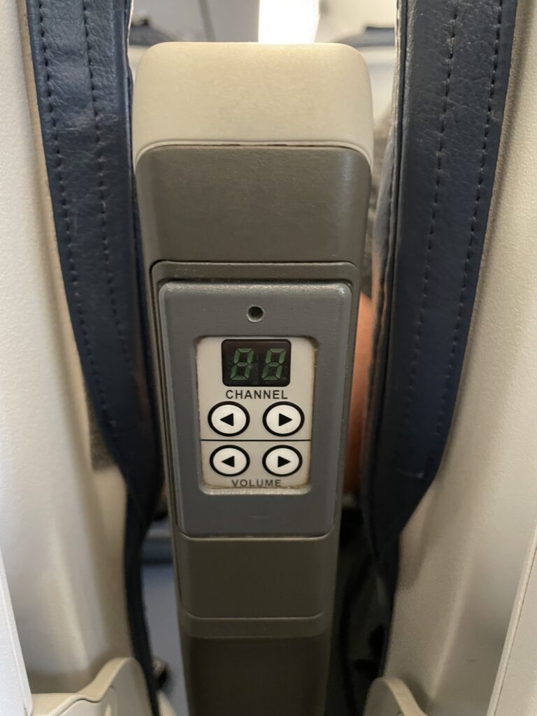 Remote control embedded into in the armrest of the aircraft seat.