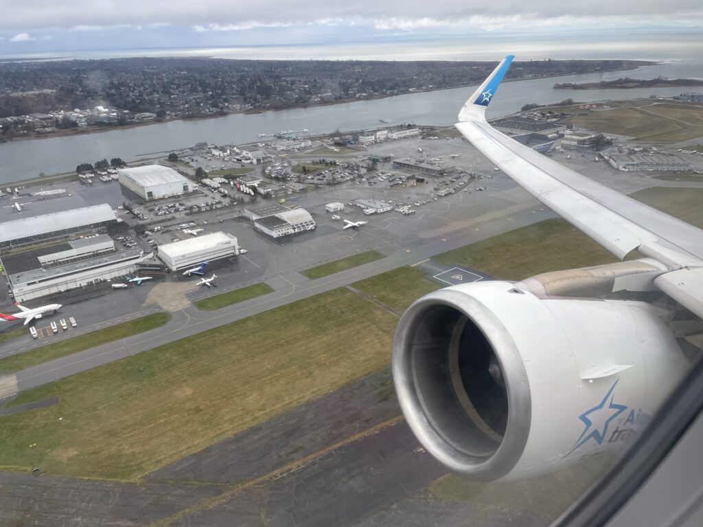 Looking out the window of an Air Transat A321ceo as it takes off. This image shows the wing, engine and the winglet of the plane.