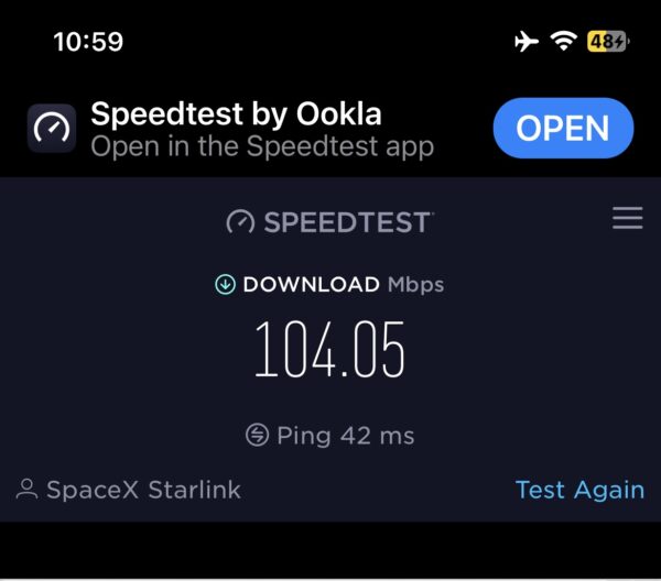 A screenshot of the speedtest for inflight Wi-Fi shows a download speed of 104.05 Mbps