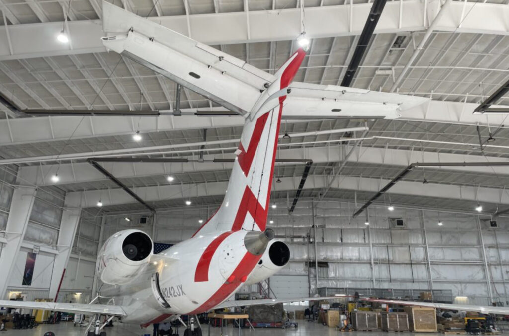 A JSX ERJ-145 parked in the hangar. This image shows the tail of the plane.