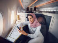 Etihad Airways Business Class with Emirati guest taking advantage of Etihad's unlimited Wi-fly
