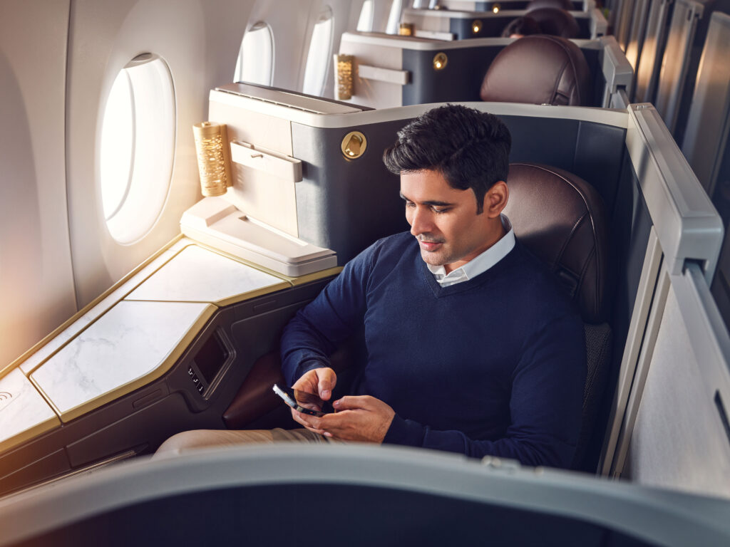 Etihad Airways Business Class with guest taking advantage of Etihad's unlimited Wi-fly