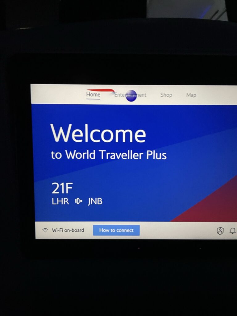 A welcome message is displayed on the in-seat IFE screen, telling passengers they're flying from London to Johannesburg. 