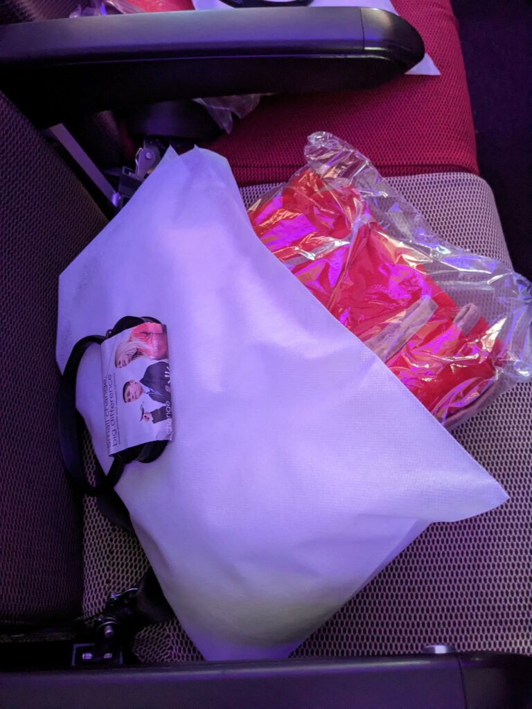 Pillow, headphones and blanket provided by Virgin for the flight.