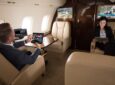 A man and a woman are working on connected devices in a private aircraft. An unlimited data plan is now available to Vista customers.