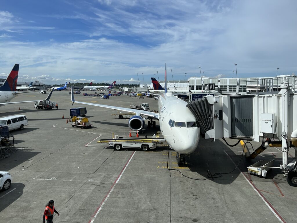 Delta's 737-900ER at the gate on a sunny day