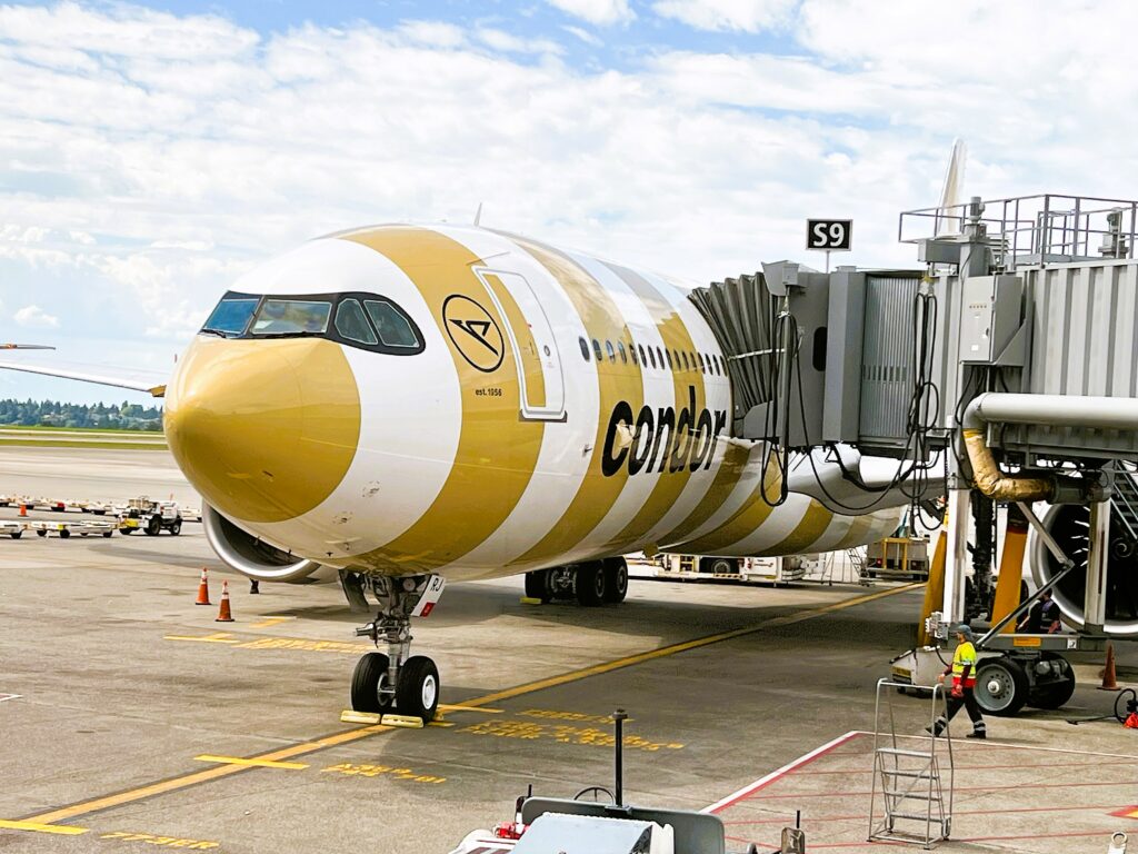 Condor Airlines' striped sand colored Airbus A330neo at the gate.