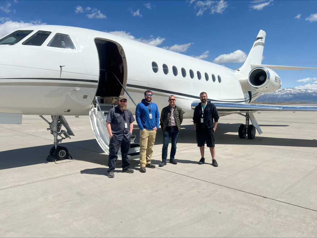 Installation team standing in front of the West Star Aviation Falcon 2000EX