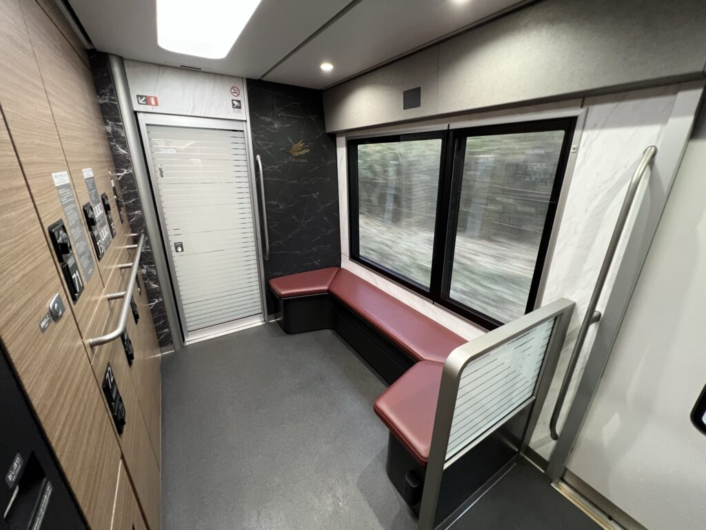 Lockers used on the train for luggage storage. A bench-style seat sits in front of the lockers.