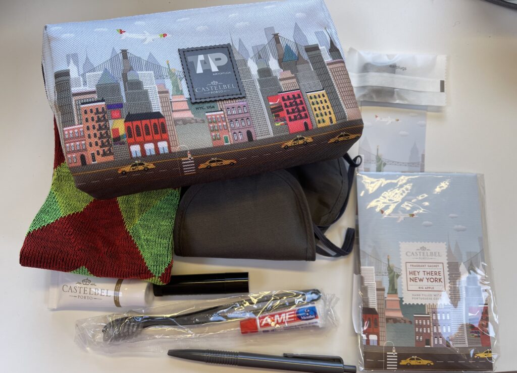 TAP's amenity kit is on display featuring city scape art on the tin.